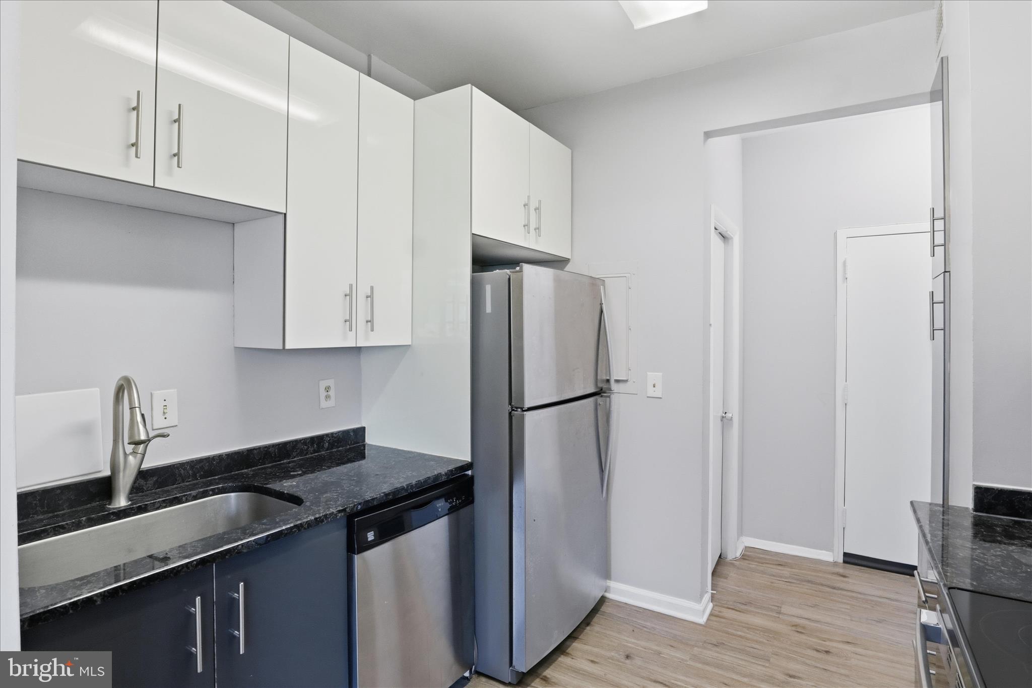 3245 Rio Drive, Unit 107 Falls Church, VA 22041 - Photo 11 of 32 a kitchen with stainless steel appliances a sink a refrigerator and cabinets