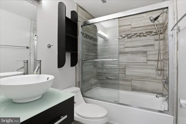 a bathroom with a bathtub and shower