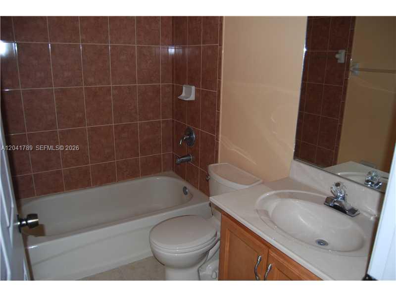 12080 Southwest 268th Street, Unit 24 Homestead, FL 33032 - Photo 12 of 29 a bathroom with a sink toilet vanity and shower