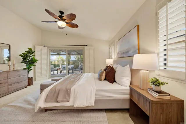 a living room with a bed furniture and a large window