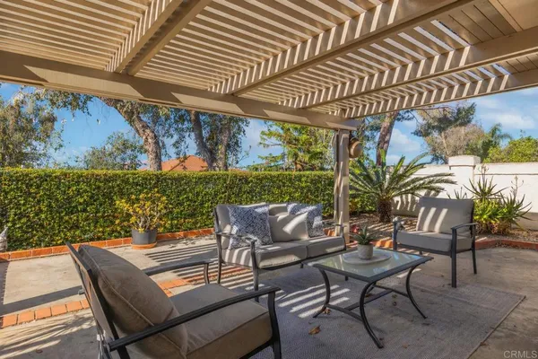 a view of a patio with a table and chairs