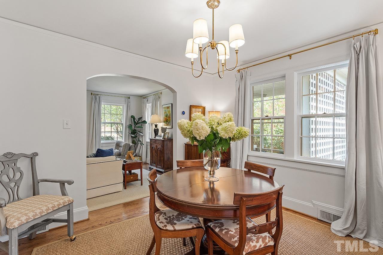 2715 Barmettler Street Raleigh, NC 27607 - Photo 5 of 19 a view of a dining room with furniture a chandelier and wooden floor