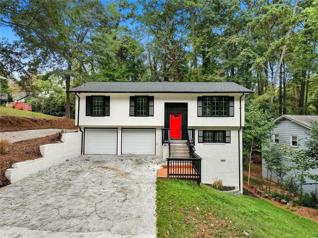 a white house that has tree in front of it