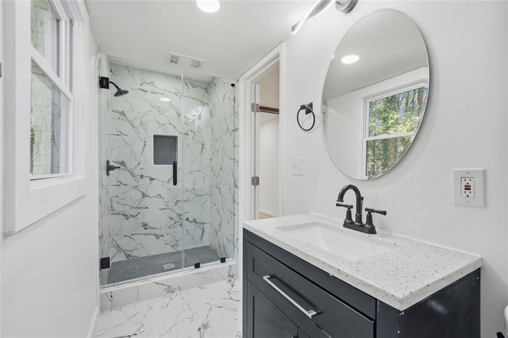 3920 Wedgefield Circle Decatur, GA 30035 - Photo 15 of 25 a bathroom with a shower sink and mirror