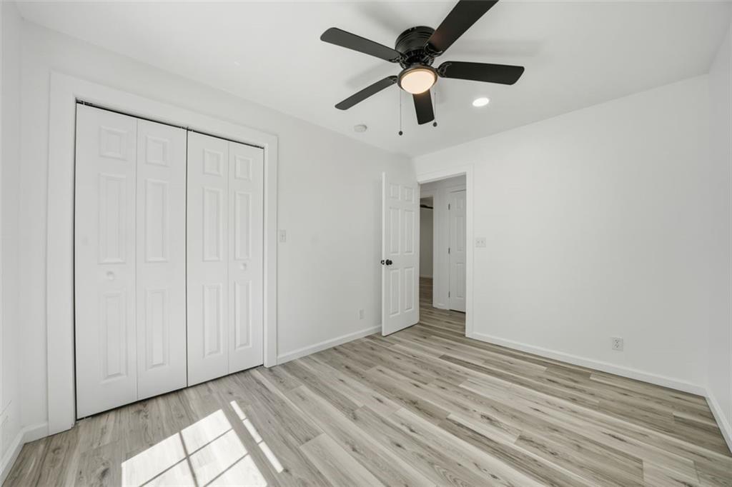 3920 Wedgefield Circle Decatur, GA 30035 - Photo 17 of 25 an empty room with a ceiling fan and a window