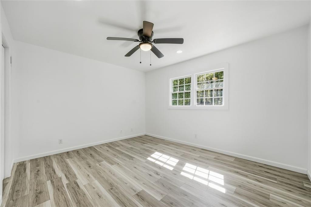 3920 Wedgefield Circle Decatur, GA 30035 - Photo 8 of 25 a view of empty room with wooden floor and fan
