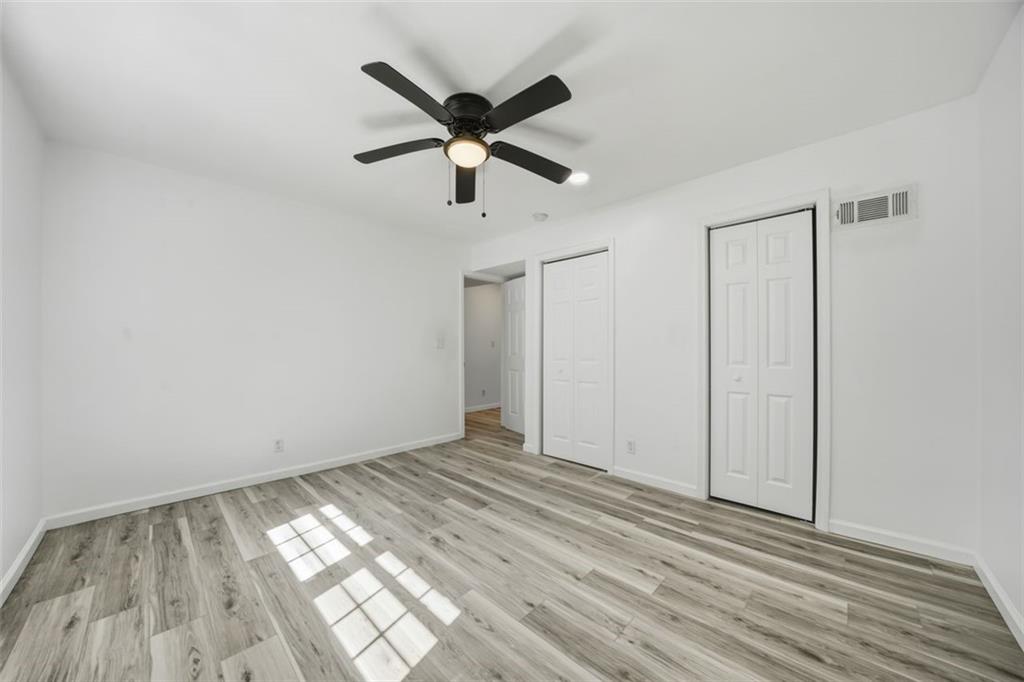3920 Wedgefield Circle Decatur, GA 30035 - Photo 10 of 25 an empty room with wooden floor and windows