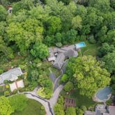 an aerial view of a house with a yard basket ball court and outdoor seating