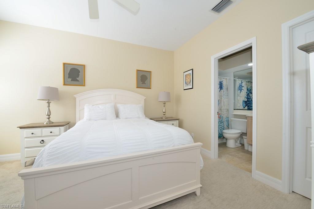 106 Cypress View Drive, Unit C8 Naples, FL 34113 - Photo 13 of 30 a bedroom with a bed and a lamp