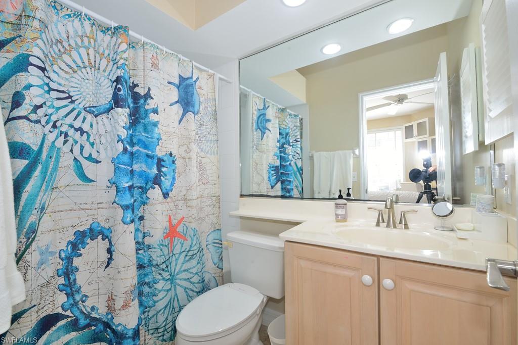 106 Cypress View Drive, Unit C8 Naples, FL 34113 - Photo 14 of 30 a bathroom with a sink mirror vanity and toilet