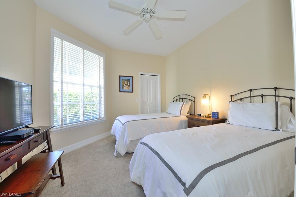 106 Cypress View Drive, Unit C8 Naples, FL 34113 - Photo 15 of 30 a bedroom with two beds and a window