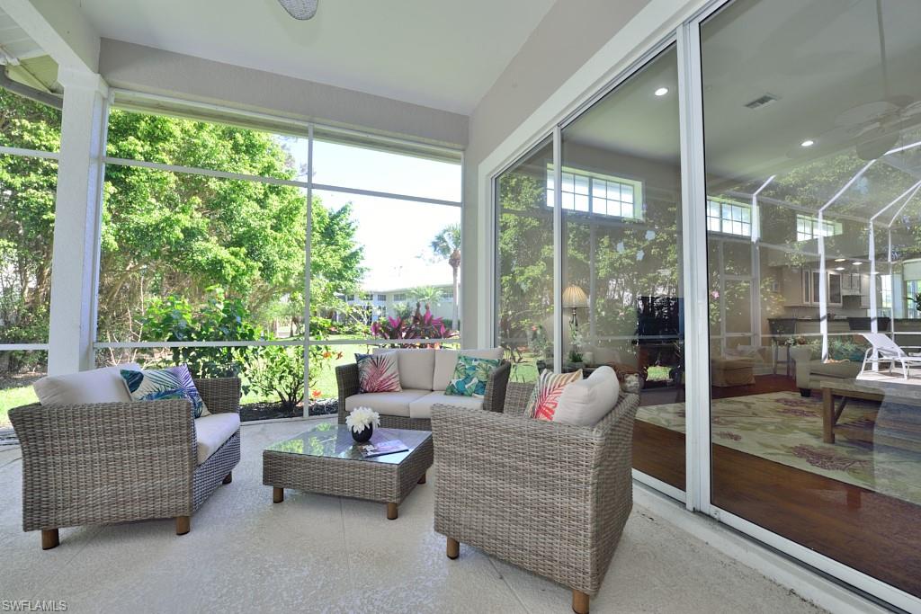 106 Cypress View Drive, Unit C8 Naples, FL 34113 - Photo 17 of 30 a living room with furniture and a large window