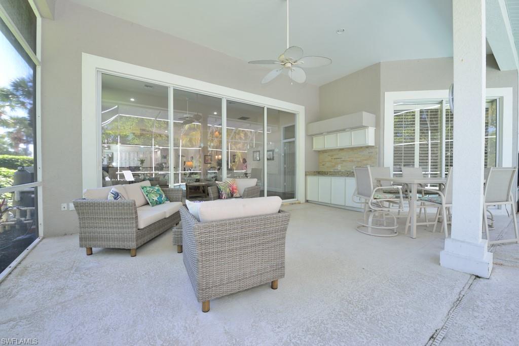 106 Cypress View Drive, Unit C8 Naples, FL 34113 - Photo 18 of 30 a living room with furniture and a large window