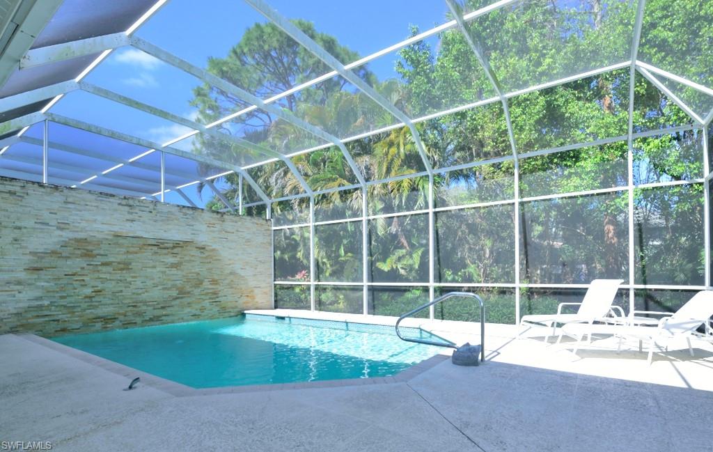 106 Cypress View Drive, Unit C8 Naples, FL 34113 - Photo 20 of 30 a view of a house with a yard and sitting area