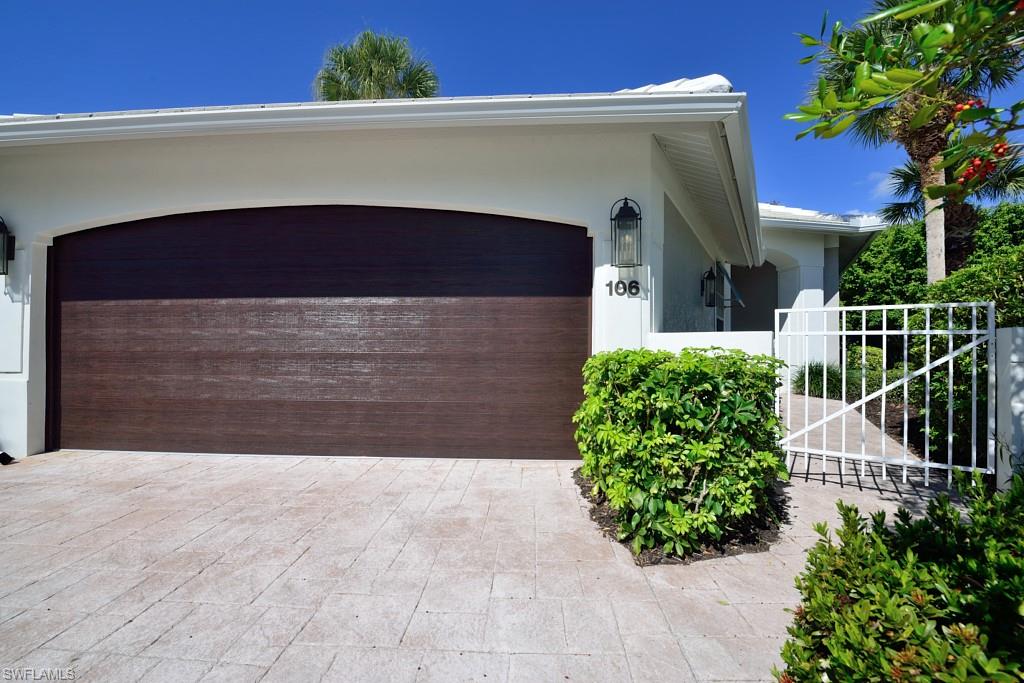 106 Cypress View Drive, Unit C8 Naples, FL 34113 - Photo 2 of 30 a front view of a house with a yard
