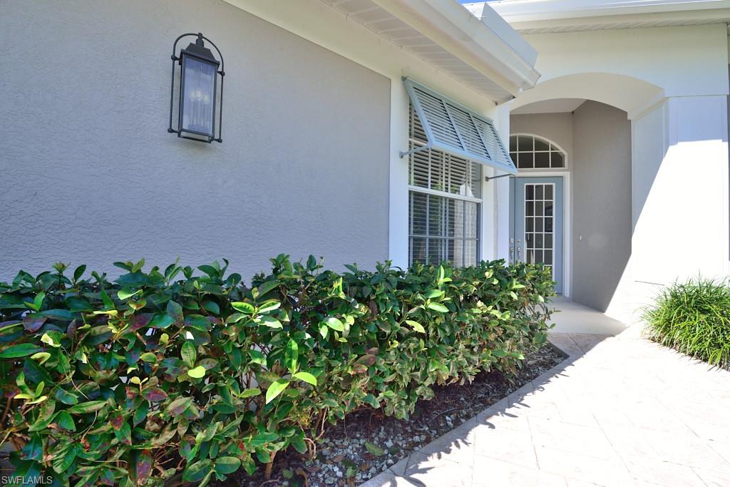 106 Cypress View Drive, Unit C8 Naples, FL 34113 - Photo 3 of 30 a front view of a house with garden