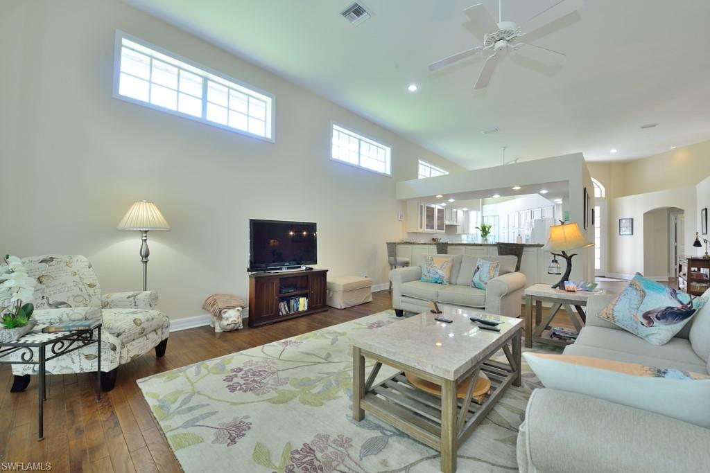 106 Cypress View Drive, Unit C8 Naples, FL 34113 - Photo 4 of 30 a living room with furniture a rug and a flat screen tv