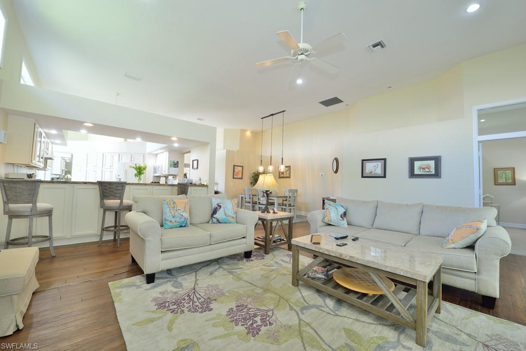 106 Cypress View Drive, Unit C8 Naples, FL 34113 - Photo 5 of 30 a living room with furniture and view of kitchen