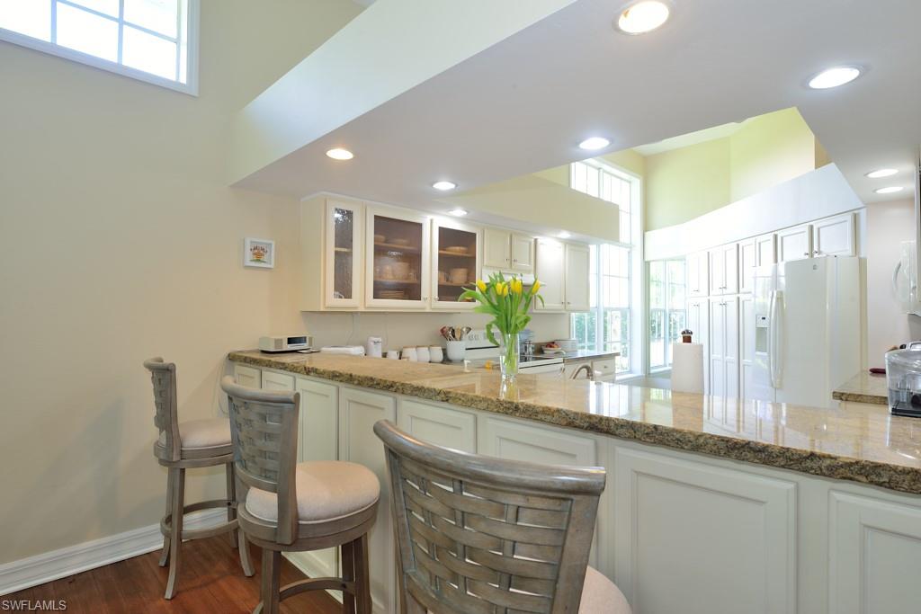 106 Cypress View Drive, Unit C8 Naples, FL 34113 - Photo 7 of 30 a bathroom with a sink and a large mirror