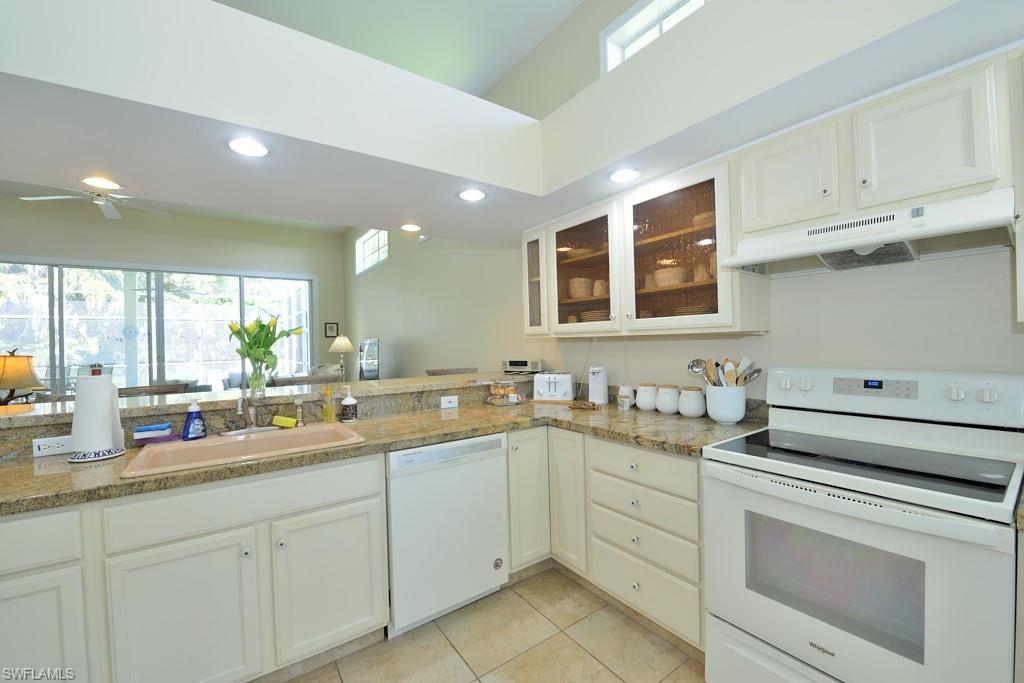 106 Cypress View Drive, Unit C8 Naples, FL 34113 - Photo 9 of 30 a kitchen with a sink and cabinets