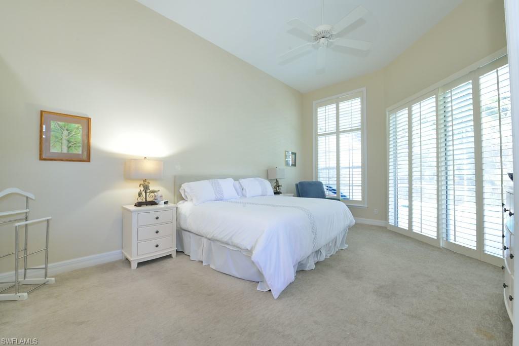106 Cypress View Drive, Unit C8 Naples, FL 34113 - Photo 10 of 30 a bedroom with bed and a large window