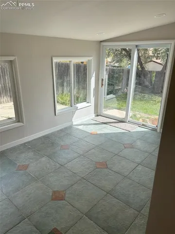 a view of an empty room with glass door and glass door