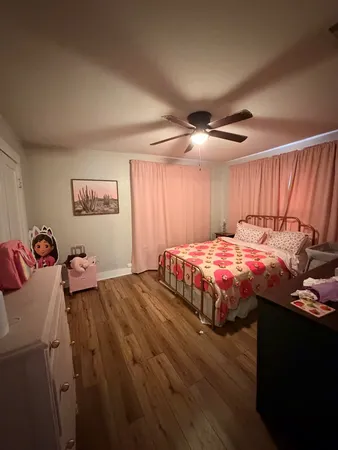 a bedroom with a bed and a ceiling fan