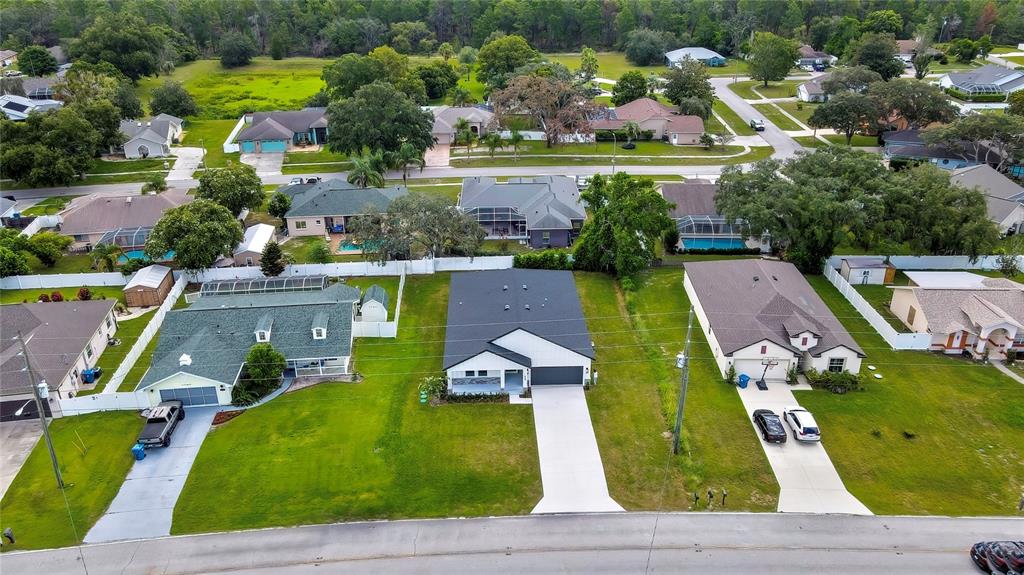 6589 Freeport Drive Spring Hill, FL 34608 - Photo 63 of 63 an aerial view of a house with a swimming pool yard and outdoor seating