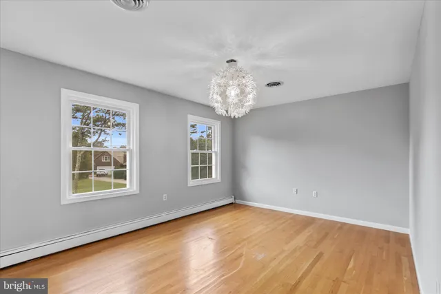 a bathroom with a granite countertop sink and a large mirror
