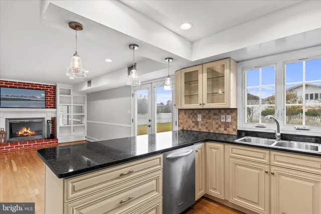 a kitchen with granite countertop a sink and a stove