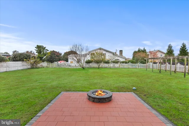 a view of a house with a yard and sitting area