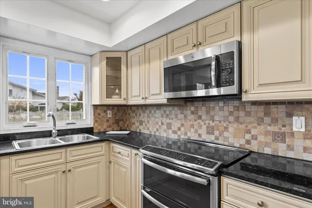 a kitchen with stainless steel appliances granite countertop a sink and cabinets