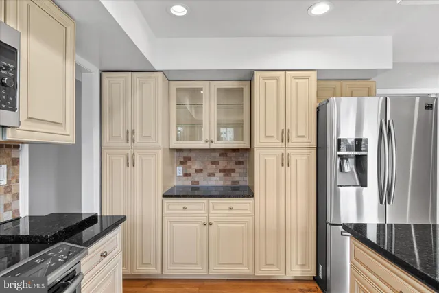 a kitchen with stainless steel appliances granite countertop a sink and a stove