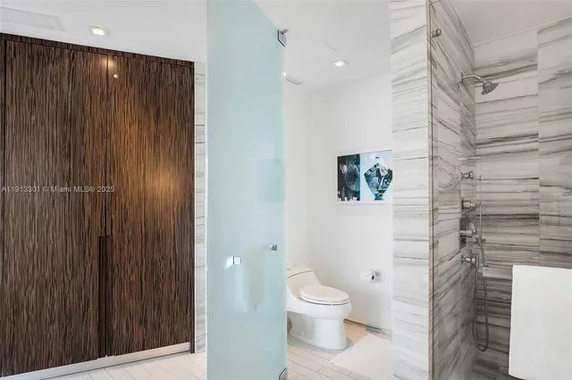 a bathroom with a toilet and a shower