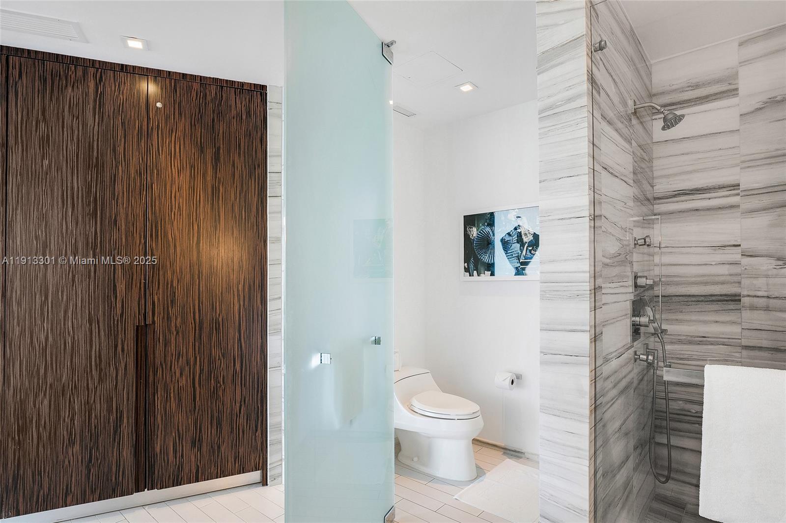 2201 Collins Avenue, Unit 431 Miami Beach, FL 33139 - Photo 13 of 20 a bathroom with a toilet and a shower