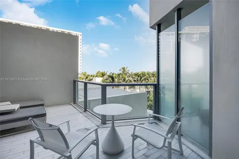 a balcony view with table and chairs