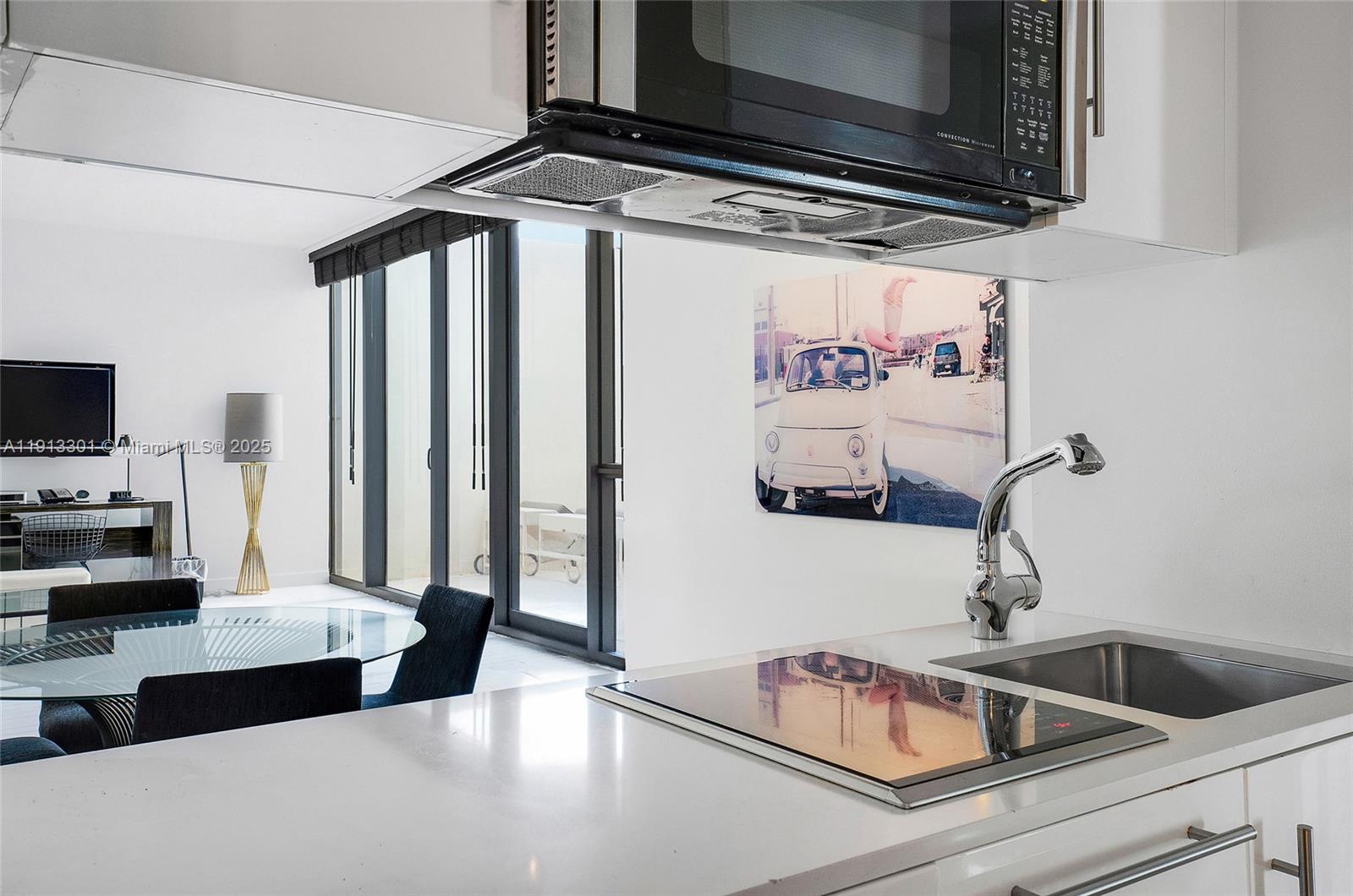 2201 Collins Avenue, Unit 431 Miami Beach, FL 33139 - Photo 7 of 20 a kitchen with a sink appliances and cabinets