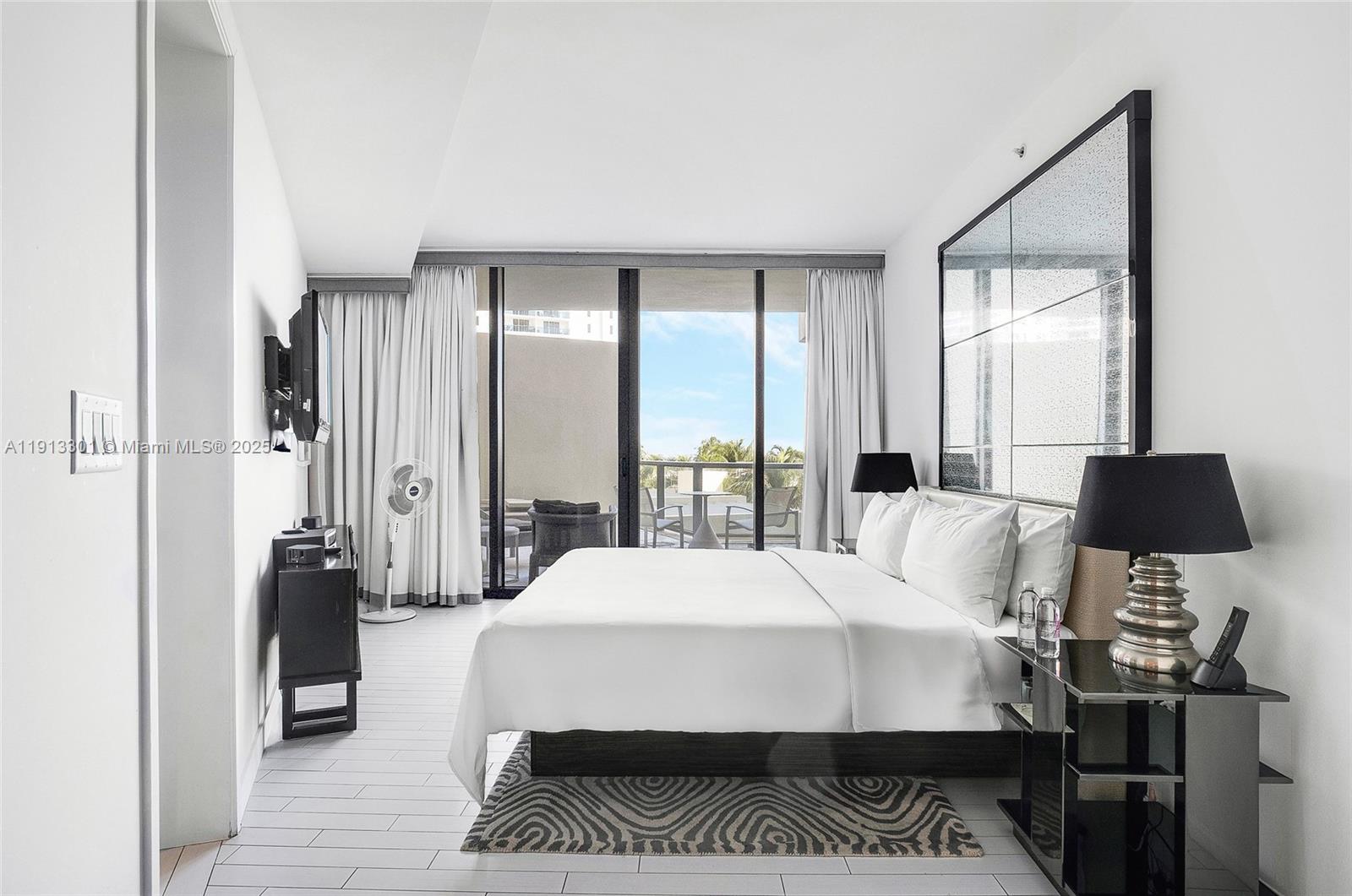 2201 Collins Avenue, Unit 431 Miami Beach, FL 33139 - Photo 8 of 20 a large bedroom with a bed and wooden floor