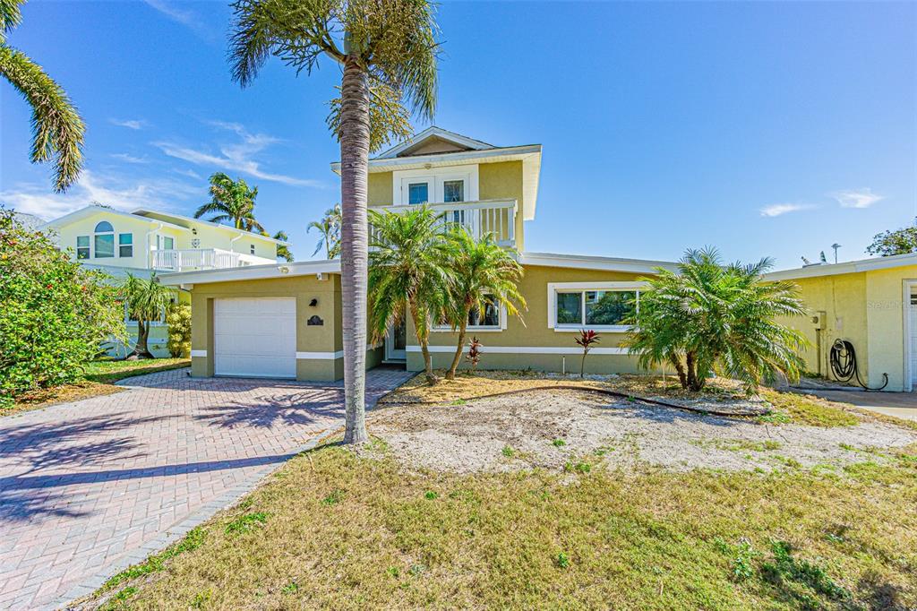 121 Wall Street Redington Shores, FL 33708 - Photo 1 of 38 a front view of a house with a yard