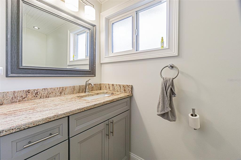 121 Wall Street Redington Shores, FL 33708 - Photo 15 of 38 a bathroom with a sink and a mirror