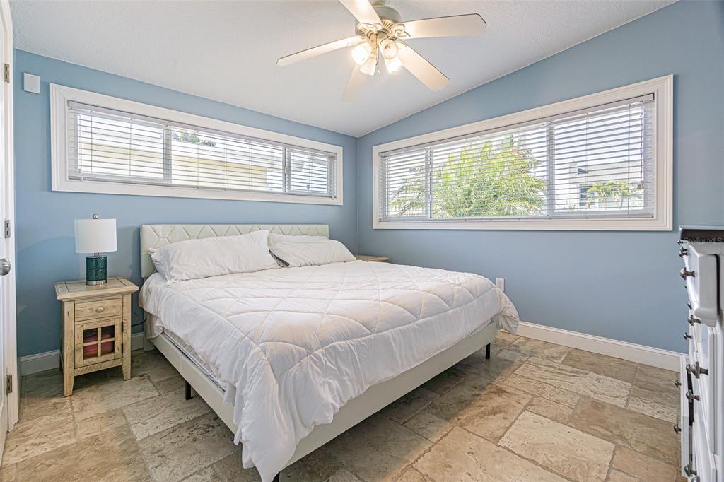 121 Wall Street Redington Shores, FL 33708 - Photo 18 of 38 a bedroom with a bed and window