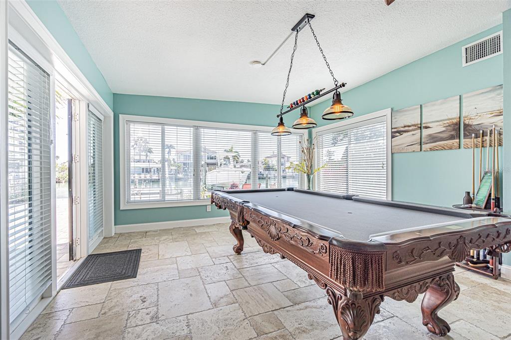 121 Wall Street Redington Shores, FL 33708 - Photo 26 of 38 a room with pool table and windows