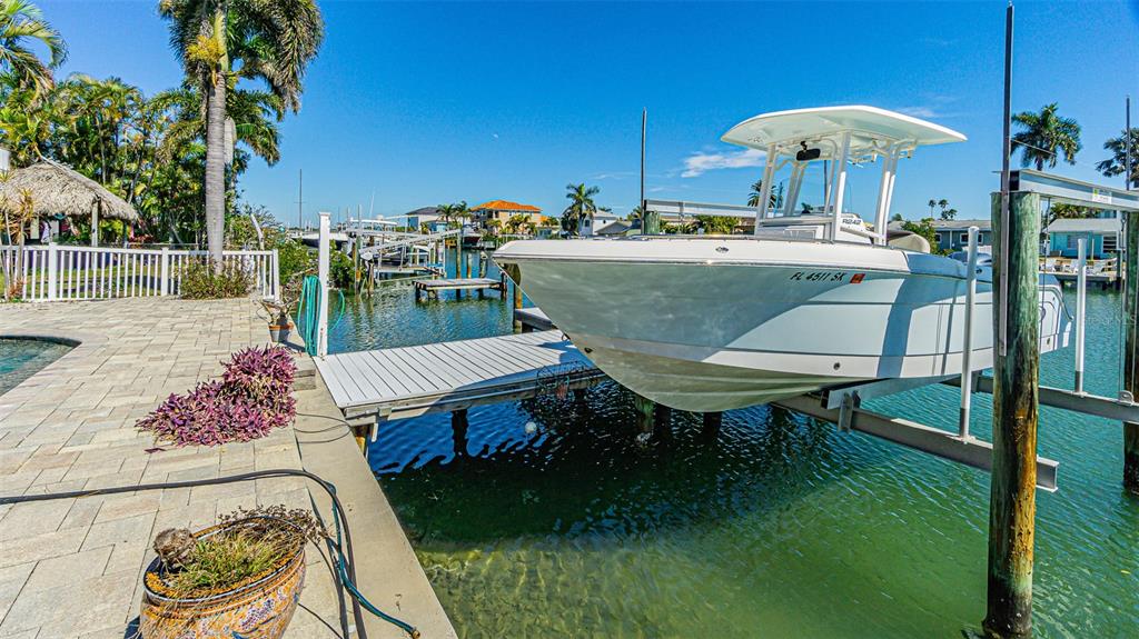 121 Wall Street Redington Shores, FL 33708 - Photo 33 of 38 a view of a patio with table and chairs potted plants with wooden floor