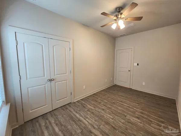 a view of an empty room with a fan