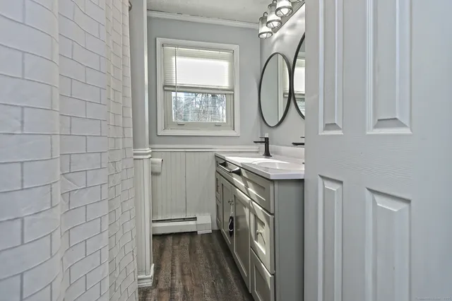 a view of a room with wooden floor