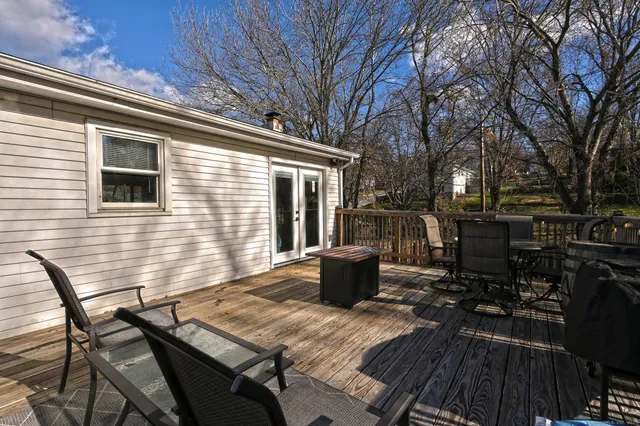 a view of a patio with table and chairs and wooden floor