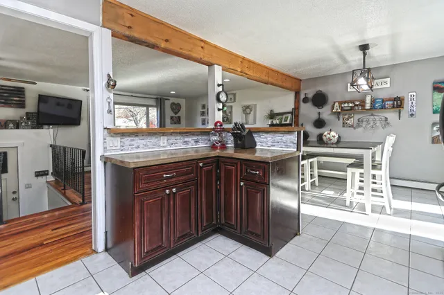 a kitchen with stainless steel appliances granite countertop a sink and a refrigerator