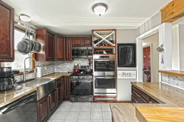 a kitchen with granite countertop a sink and cabinets