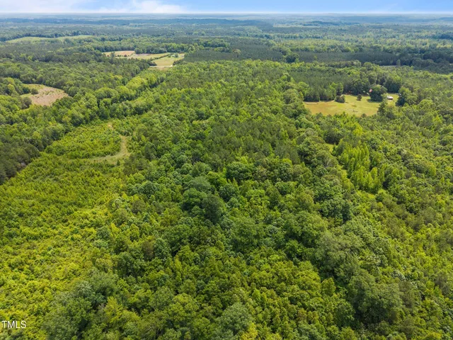 an aerial view of a houses with a yard