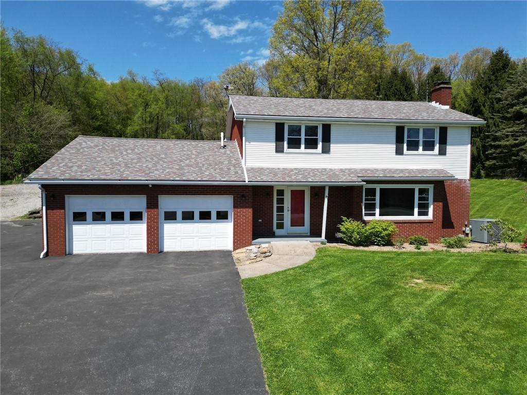 119 Staff Road Slippery Rock, PA 16057 - Photo 1 of 40 a front view of a house with a yard and garage